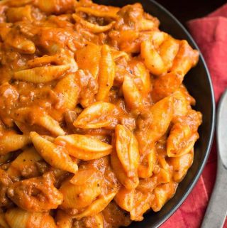 Instant Pot Cheesy Meaty Shells taste almost like a bowl of lasagna pasta! Rich tomato flavor makes the meat sauce delicious. Two kinds of cheese take this pressure cooker Italian pasta dish over the top! simplyhappyfoodie.com #instantpotrecipes #inatantpotpasta #instantpotlasagnapasta #pressurecookeritalianpasta