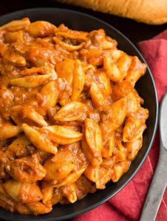 Cheesy Meaty Shells on a black plate