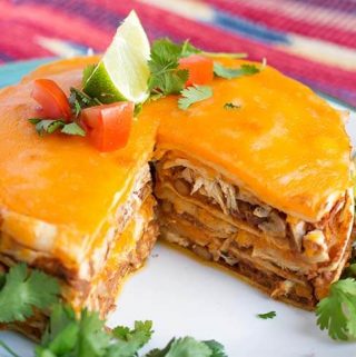 Instant Pot Chicken Taco Pie is fun and easy to make. Layers of chicken, beans, cheese, and tortillas are cooked together to make a delicious dinner. Make this pressure cooker taco pie with pantry ingredients you probably already have! simplyhappyfoodie.com #instantpotrecipes #instantpottacopie #instantpotchickentacopie #pressurecookertacopie