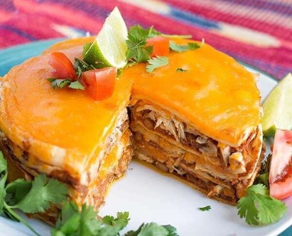 Chicken Taco Pie on a white plate with a piece removed, showing layers of pie