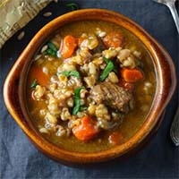 Instant Pot Beef & Barley Soup with Pistou in a brown bowl
