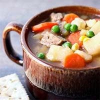 Instant Pot Steak Soup in a brown bowl with handle