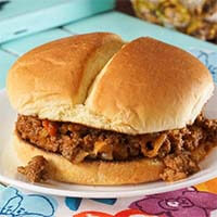 Hawaiian Sloppy Joes on a hamburger bun on a white plate