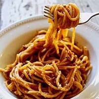 Instant Pot Spaghetti and Meat Sauce in a white bowl with fork