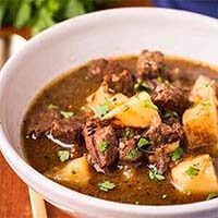 Instant Pot Meat and Potatoes Beef Stew in a white bowl