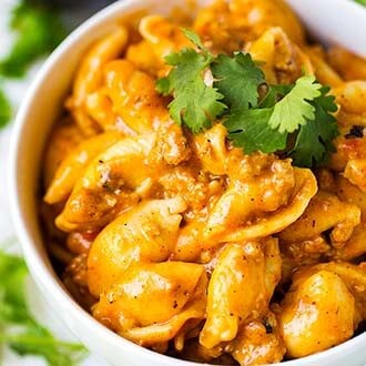 Cheesy Taco Pasta in a white bowl topped with fresh cilantro