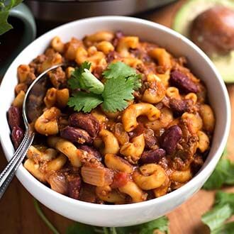 Chili Mac in a white bowl with silver spoon