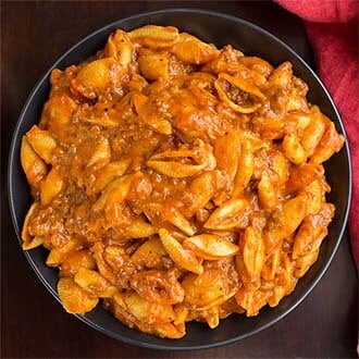 Cheesy Meaty Shells in a black bowl