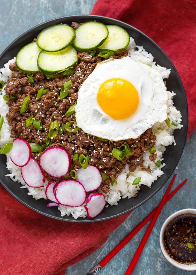 Korean Ground Beef over white rice topped with sliced radish and cucumber and cooked egg