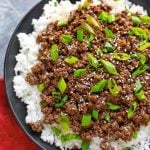 Korean Ground Beef - Bulgogi over white rice on a black plate