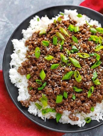 Korean Ground Beef - Bulgogi over white rice on a black plate