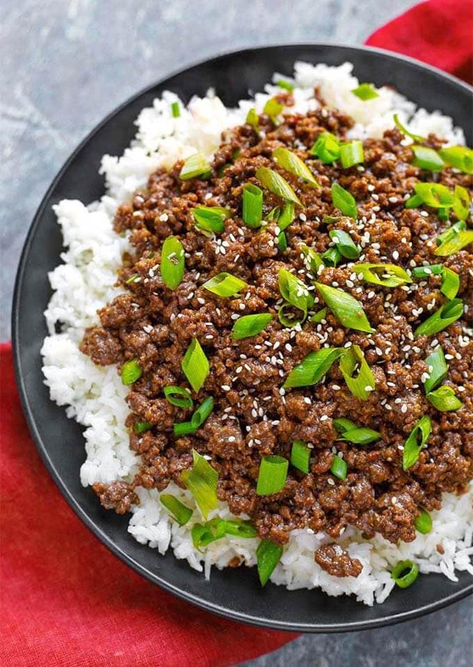 Korean Ground Beef - Bulgogi over white rice on a black plate