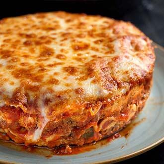 Round Lasagna on a gray plate