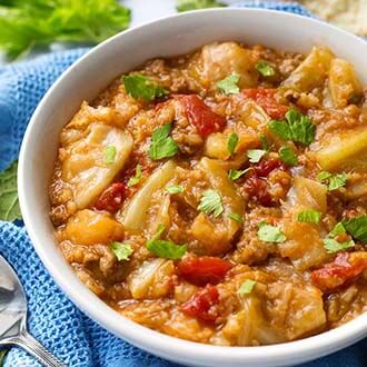 Unstuffed Cabbage Rolls in a white bowl on a blue napkin