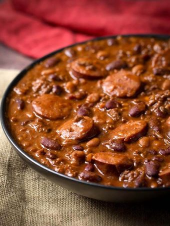 Cowboy Beans in a black bowl on a beige napkin