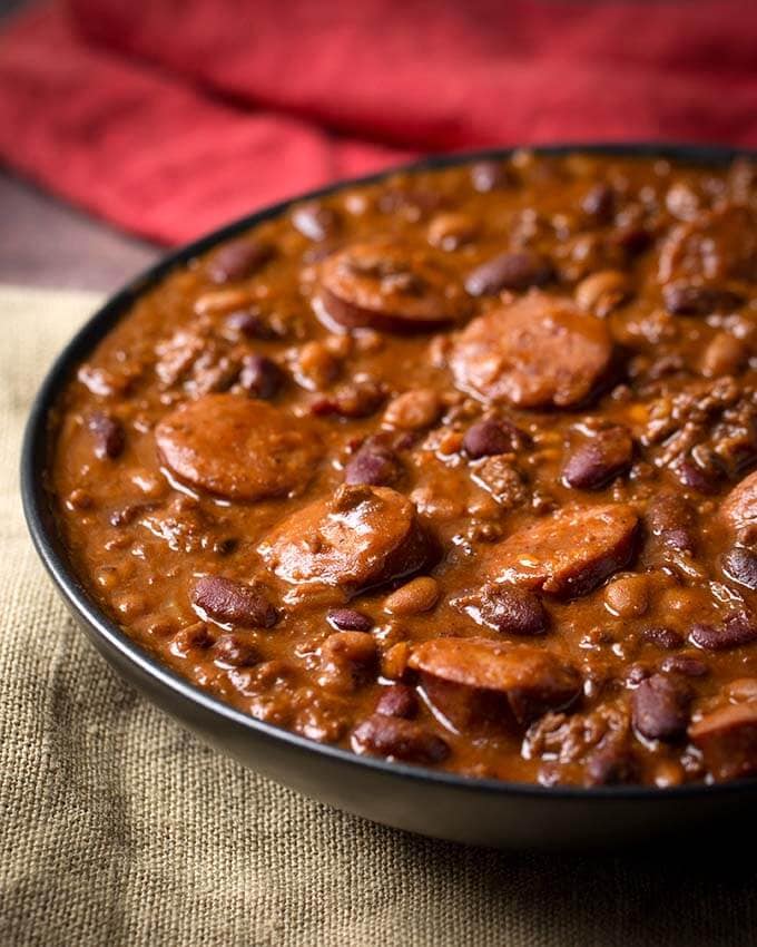 Cowboy Beans in black bowl on beige fabric