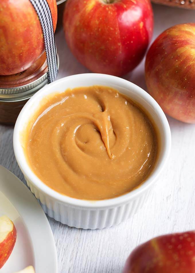 Small bowl of Dulce de Leche Caramel next to apples