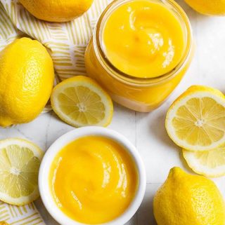 Instant Pot Lemon Curd is a delicious confection made with lemons, eggs, & butter. It's delicious on cheesecakes, pastries, yogurt, toast, and as a filling. Pressure cooker lemon curd is a tart-sweet treat! simplyhappyfoodie.com #instantpotrecipes #instantpotlemoncurd #instantpotdesserts #pressurecookerlemoncurd