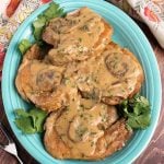 Top view of Pork Chops with Mushroom Gravy on a blue plate