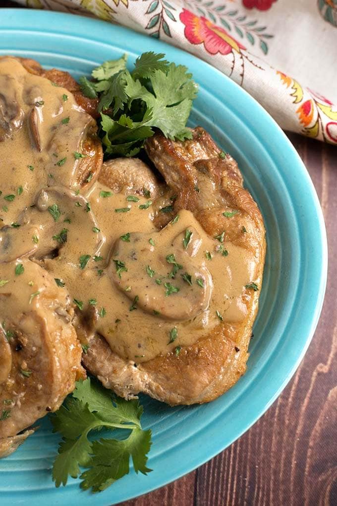 Closeup of Pork Chops with Mushroom Gravy on a blue plate