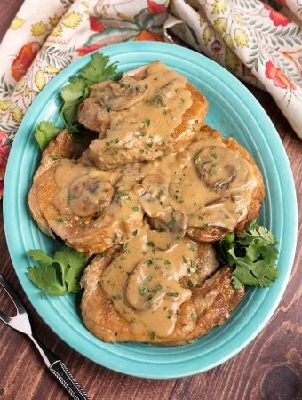 Top view of Pork Chops with Mushroom Gravy on a blue plate