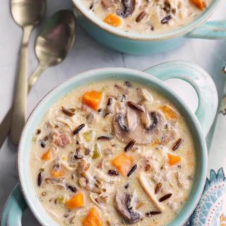 Instant Pot Wild Rice Soup with Chicken is delicious and hearty. With wild rice, mushrooms, herbs and a creamy broth. Pressure Cooker wild rice soup is amazing and easy to make! simplyhappyfoodie.com #instantpotrecipes #instantpotwildricesoup #instantpotsoup #pressurecookerwildricesoup