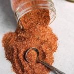 rotisserie chicken spice rub spilling out of small glass jar