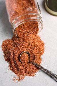 rotisserie chicken spice rub spilling out of small glass jar