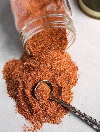 rotisserie chicken spice rub spilling out of small glass jar