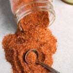 Rotisserie Chicken Spice Rub spilling from a jar