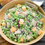 Creamy Pea Salad in a wood bowl with fork.