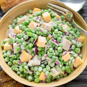 Creamy Pea Salad in a wood bowl with fork.
