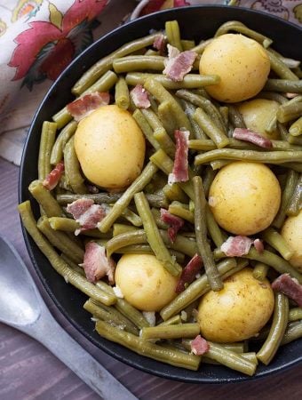 Green Beans with New Potatoes and Bacon on a black plate