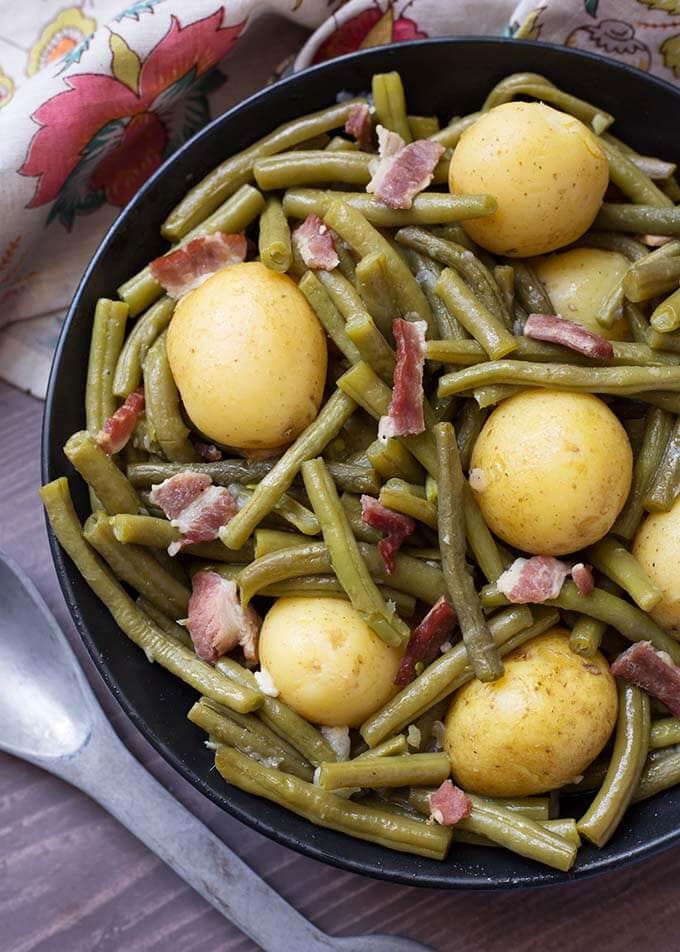 Green Beans with New Potatoes and Bacon on a black plate