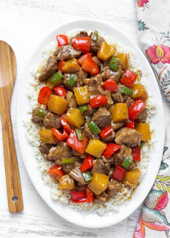 Instant Pot Hawaiian Pineapple Pork brings Hawaiian and Asian flavors to tender chunks of pork, with pineapple and red bell peppers. Pressure cooker Hawaiian Pineapple Pork over rice is so delicious! simplyhappyfoodie.com #instantpotrecipes #instantpothawaiianpork #instantpotpineapplepork #pressurecookerpineapplepork #pressurecookerhawaiianpork instant pot recipes
