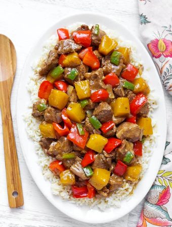 Hawaiian Pineapple Pork over white rice on a white oblong platter