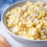Slow Cooker Creamed Corn is one of my favorite vegetable side dishes. The creaminess and sweet corn flavor make this crock pot creamed corn much better than the canned stuff. simplyhappyfoodie.com #slowcookercreamedcorn #crockpotcreamedcorn #creamedcorn creamed corn recipe
