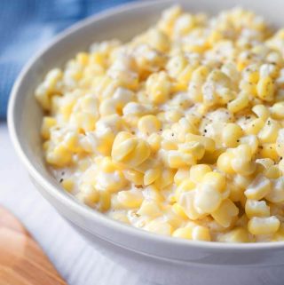 Slow Cooker Creamed Corn is one of my favorite vegetable side dishes. The creaminess and sweet corn flavor make this crock pot creamed corn much better than the canned stuff. simplyhappyfoodie.com #slowcookercreamedcorn #crockpotcreamedcorn #creamedcorn creamed corn recipe