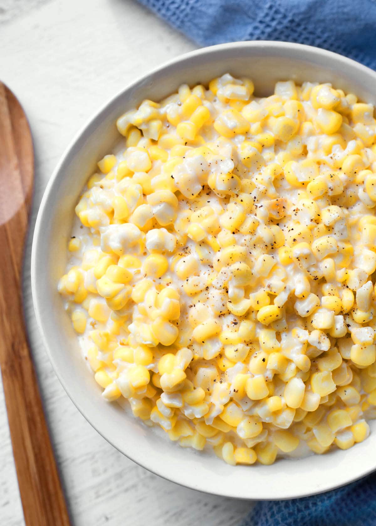 Slow Cooker Creamed Corn in a white bowl