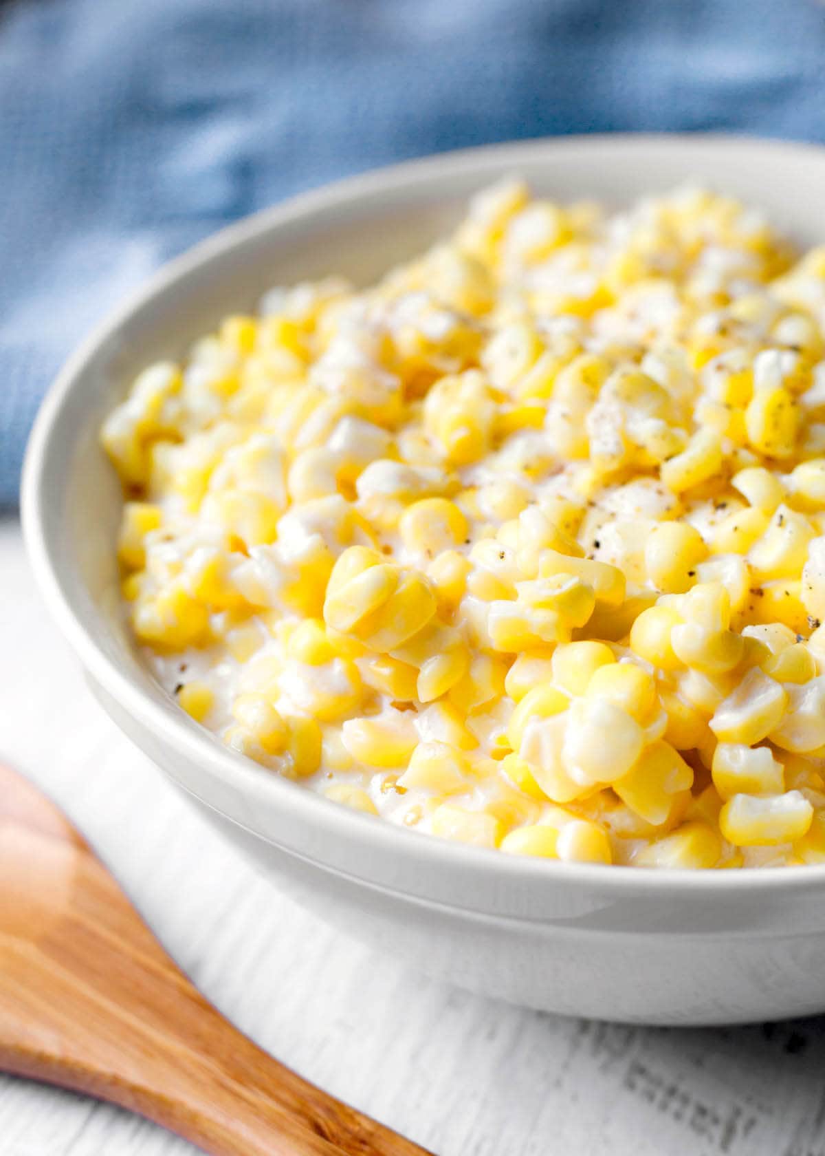 Slow Cooker Creamed Corn in a white bowl