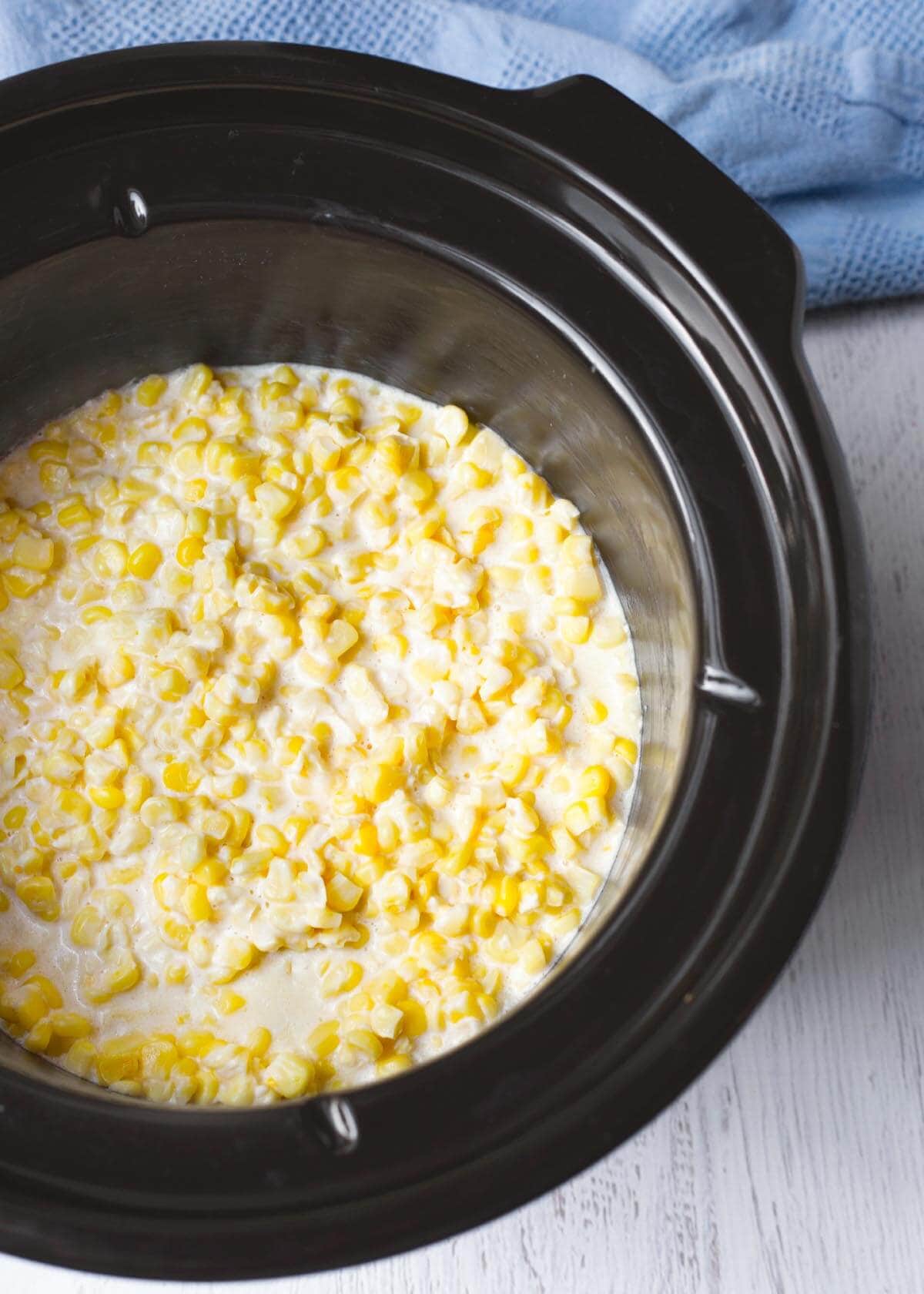 Slow Cooker Creamed Corn in a black crock