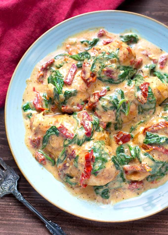 Creamy Tuscan Chicken on a blue plate