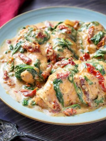 Creamy Tuscan Chicken on a blue plate