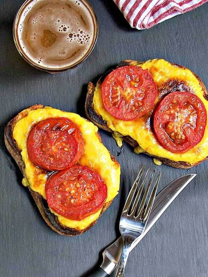 Two Welsh Rarebit next to a silver fork and knife