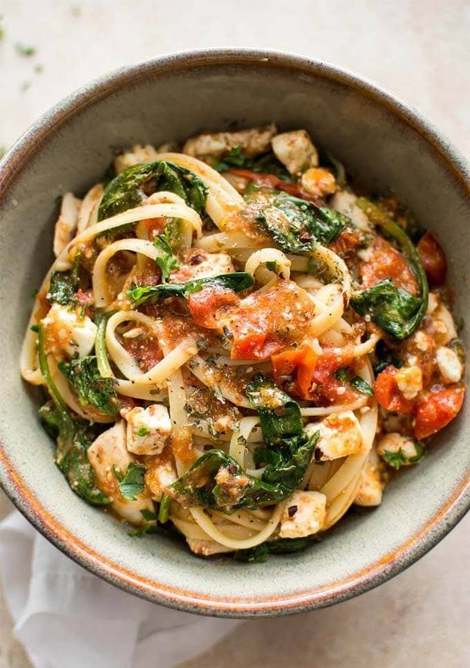 chicken feta spinach pasta in a gray stoneware bowl