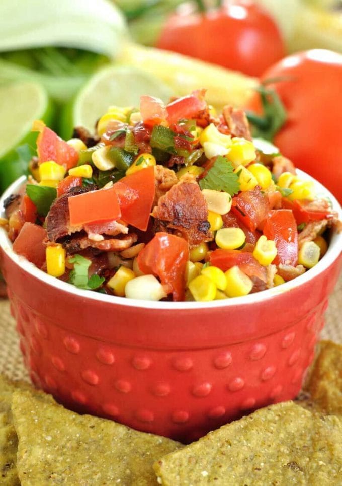 chipotle corn and bacon salsa in a red bowl