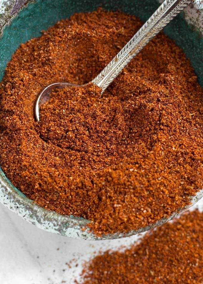 Homemade Fajita Seasoning in a turquoise bowl with small teaspoon