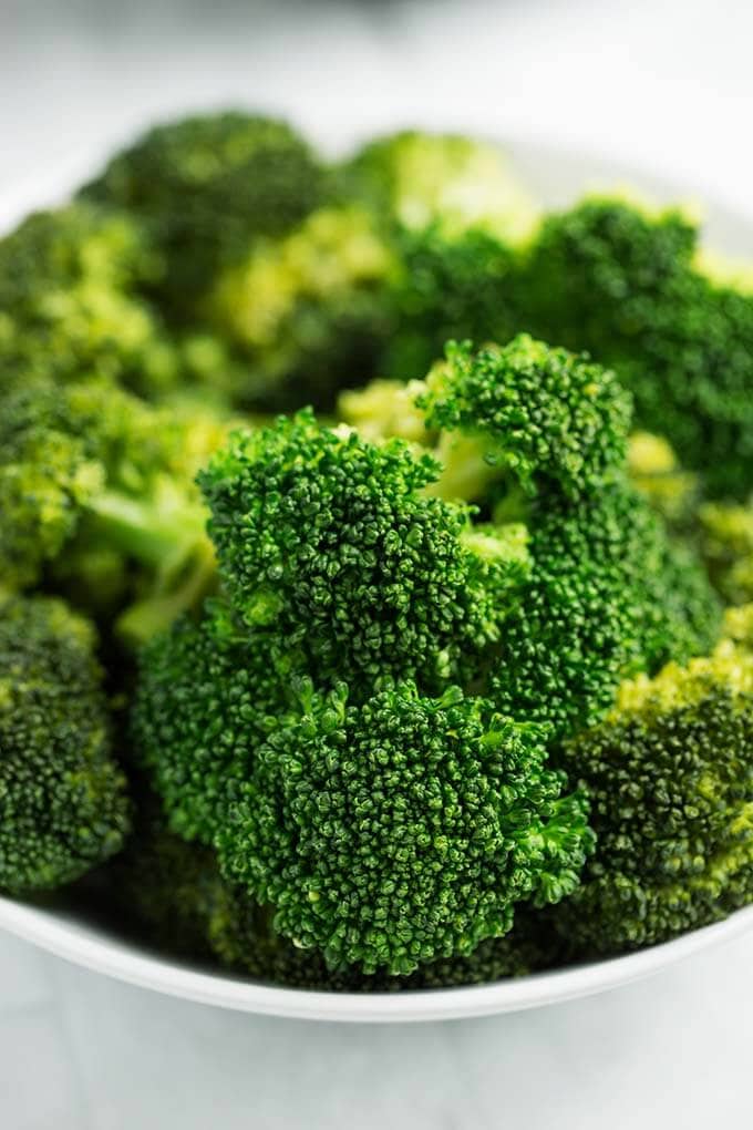 Closeup of cooked Broccoli in a white bowl