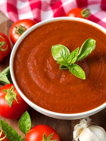 Marinara Fresh Tomato Sauce in a white bowl topped with fresh basil