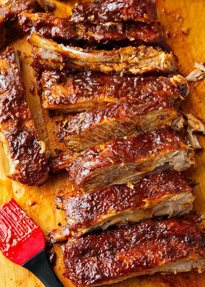 Ribs covered in Barbecue Sauce on a wooden cutting board